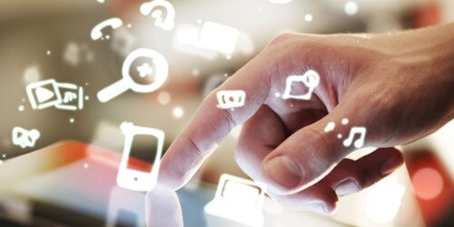 There are new tools that have emerged in the world of social media that are going to change the way you work for the better. Master a few of them to help with your everyday tasks, advancing your career and giving you the edge you need at top marketing firms. man touching a tablet with cartoon icons coming off of the screen