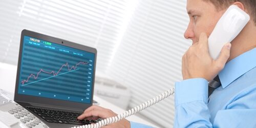 Tips for decreasing bounce rate Man on a phone looking at a graph of his computer