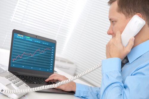 Tips for decreasing bounce rate Man on a phone looking at a graph of his computer