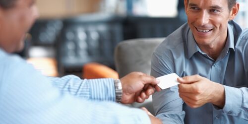 To fit the ever-changing world of marketing, eccentric job titles are emerging for certain professionals. man giving his business card to another man while shaking his head