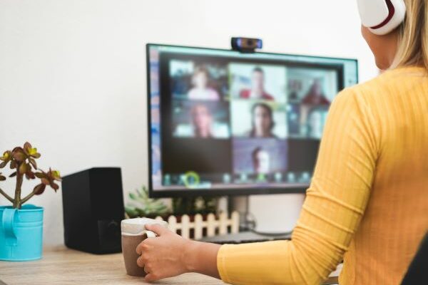 virtual coffee date with co-workers virtual team bonding_ woman on computer for virtual team bonding coffee date