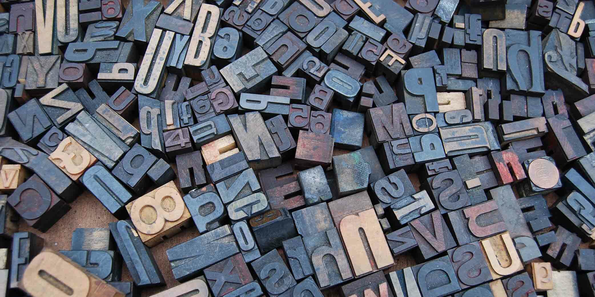 copwriting-trends-2021-letters Wooden blocks with letters and numbers all laying in a jumble on the floor.