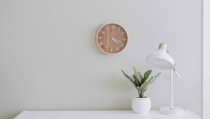 Four Day Work Week desk with clock and lamp four day work week