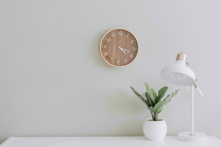 Four Day Work Week desk with clock and lamp four day work week
