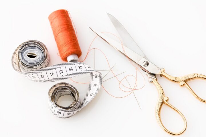 Tailor Your Resume to Job Description thread, scissors, and measuring tape on white background - tailor your resume to job description