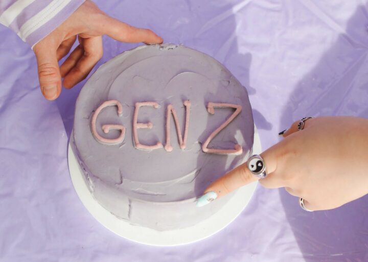 Gen z in the workplace hands on light purple cake that says "gen z" - gen z in the workplace