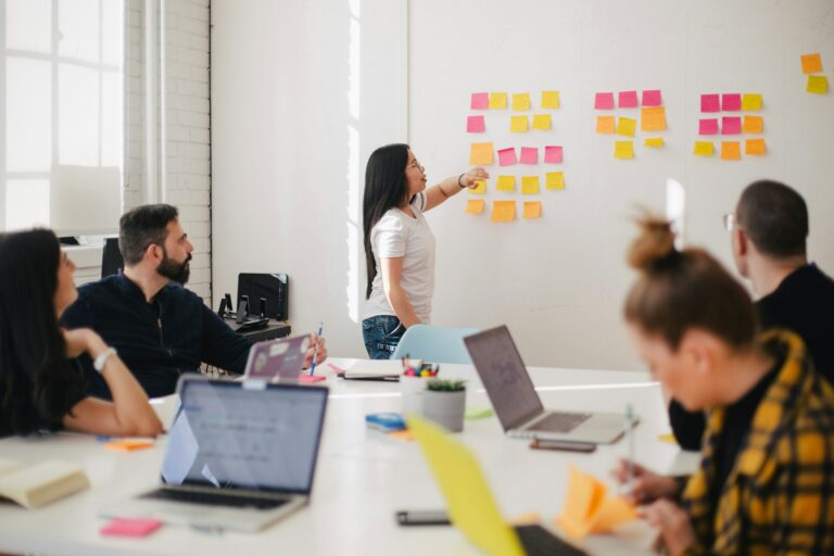 how to hire a web designer woman at wall with post-it for a web designer meeting