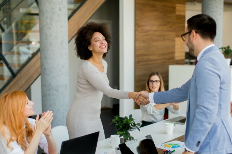 top 10 questions to ask any embedded teams vendor-1 two professionals shaking hands as if in a meeting asking the top 10 questions to ask any embedded teams vendor