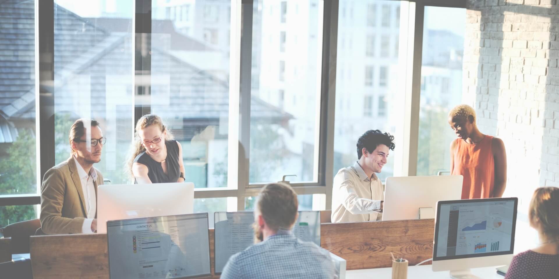 marketing team on computers implementing an AI marketing pilot